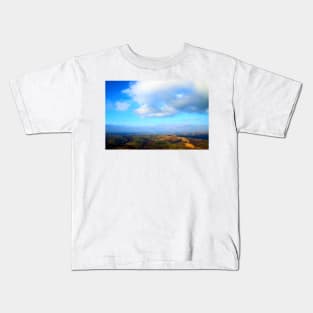 View from above on a hilly landscape under the blue sky with clouds Kids T-Shirt